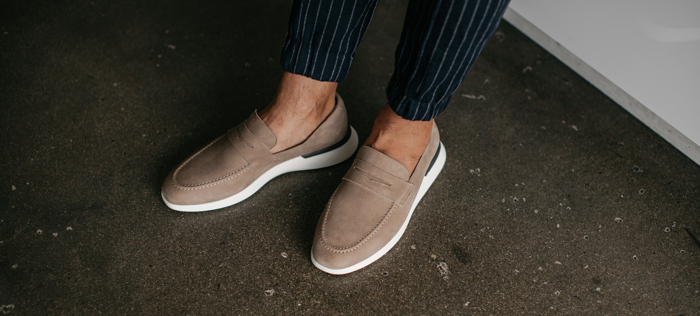 Ankle down view of man wearing Hybrid Dress shoe Crossover Loafer in Stone