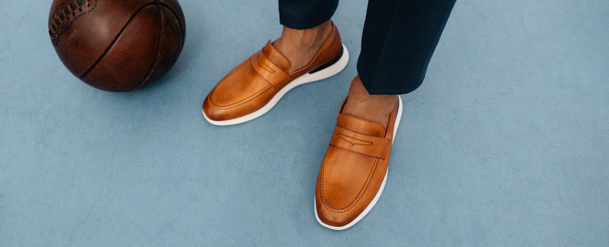 Ankle down view of man wearing wearing Hybrid Dress shoe Crossover Loafer in Honey