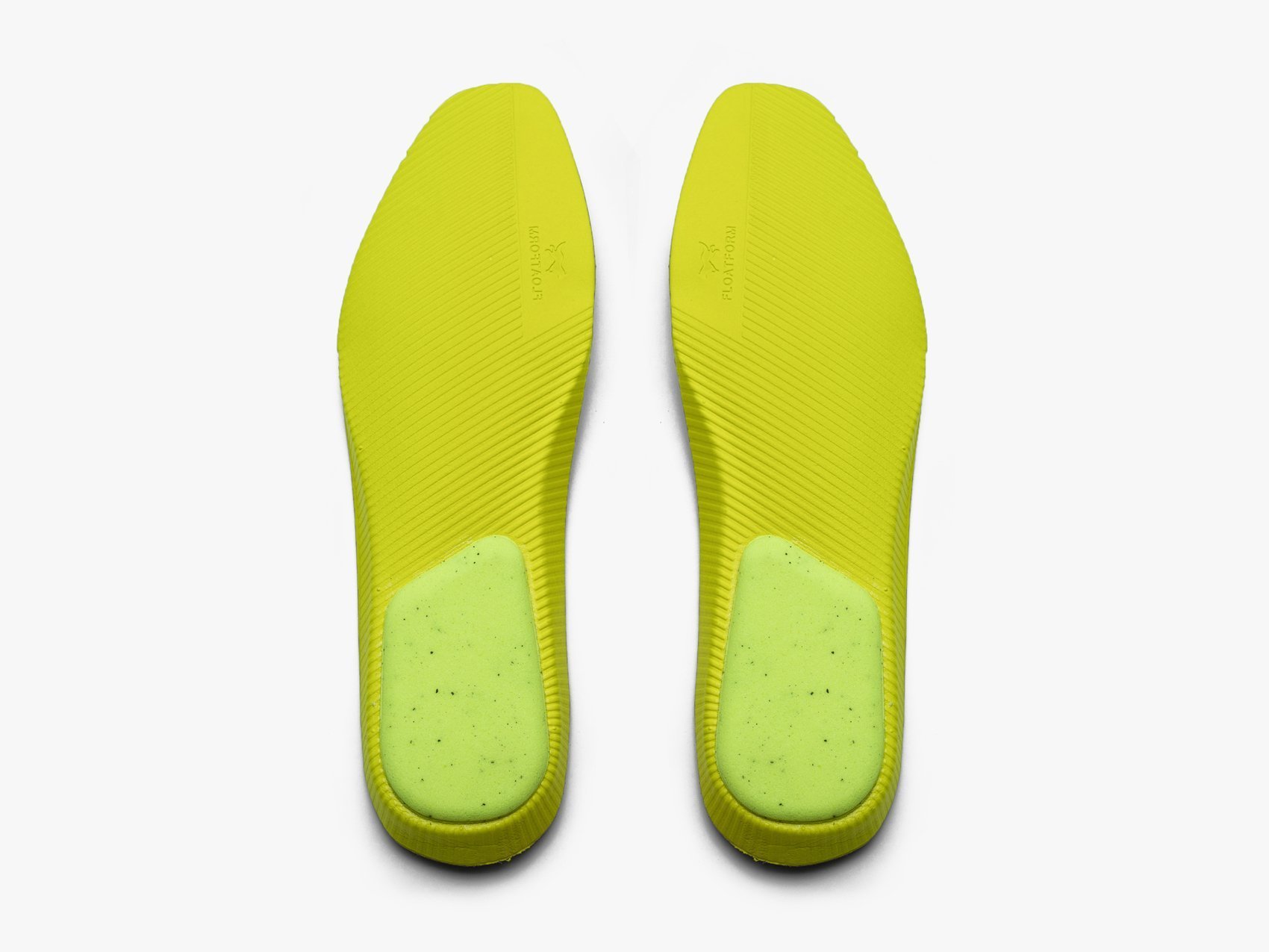 Detail view of yellow shoe sole on a white background
