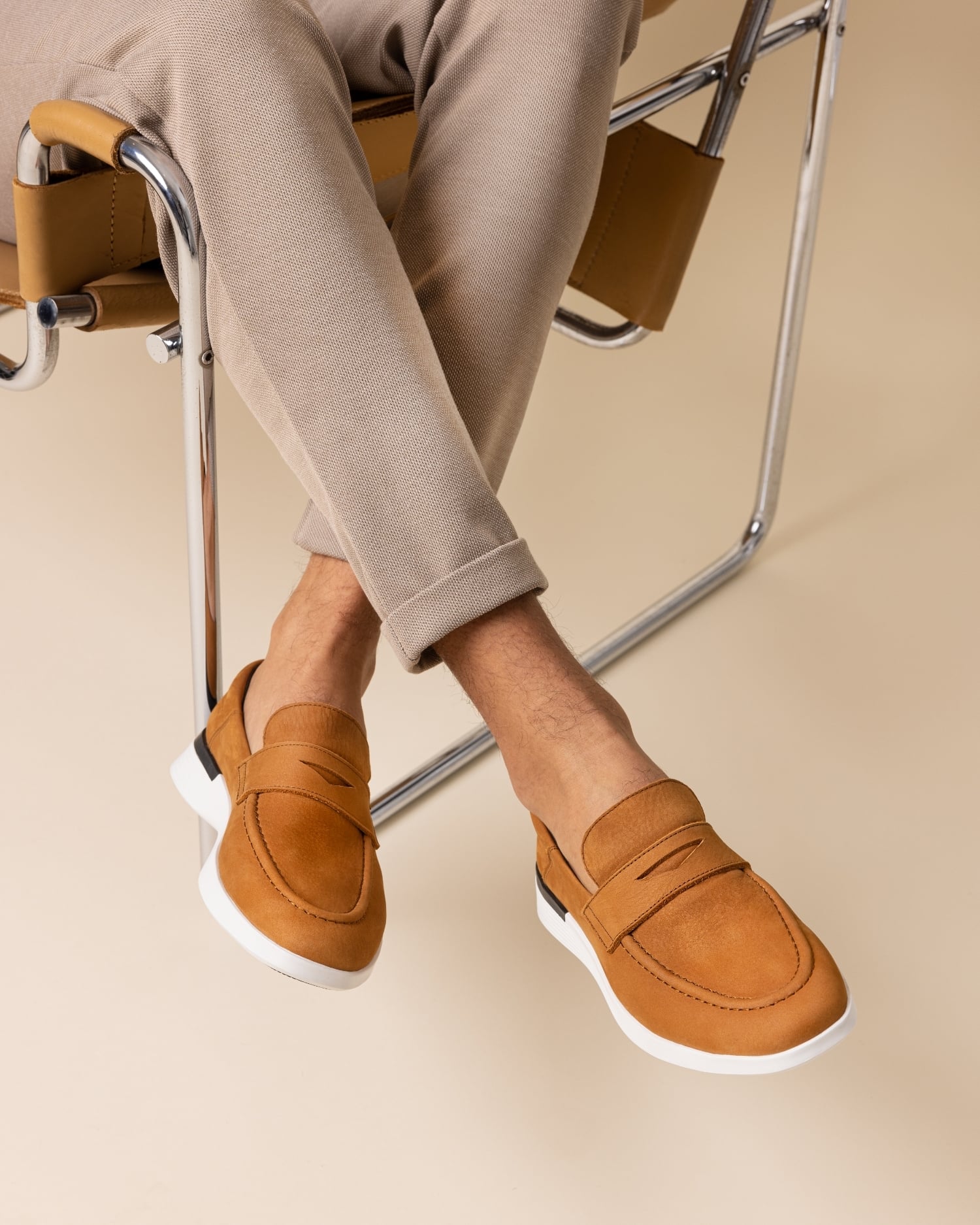 Knee down view of a man wearing Hybrid Dress shoe Crossover Loafer in Cognac