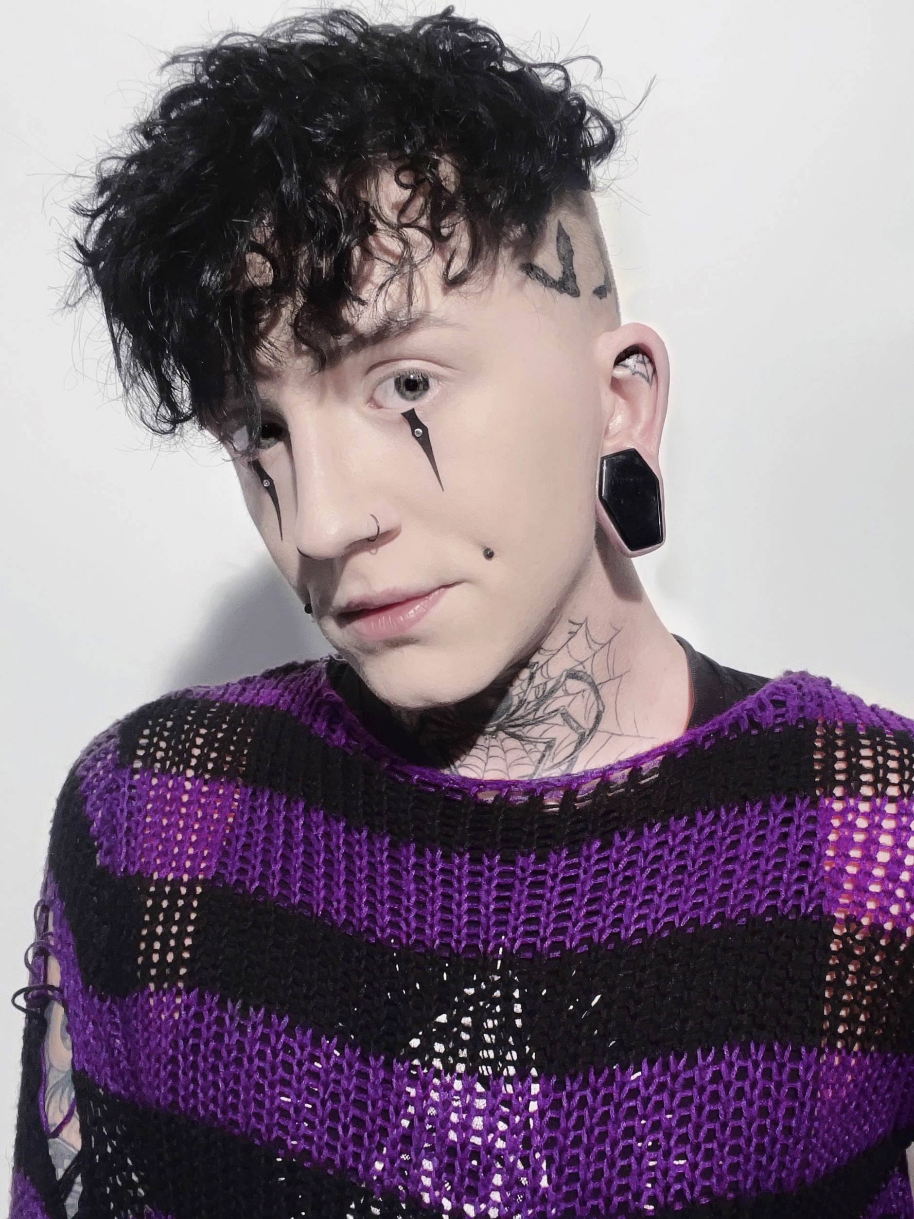 Boy wearing large  Black Coffin Glass Plug / Gauge