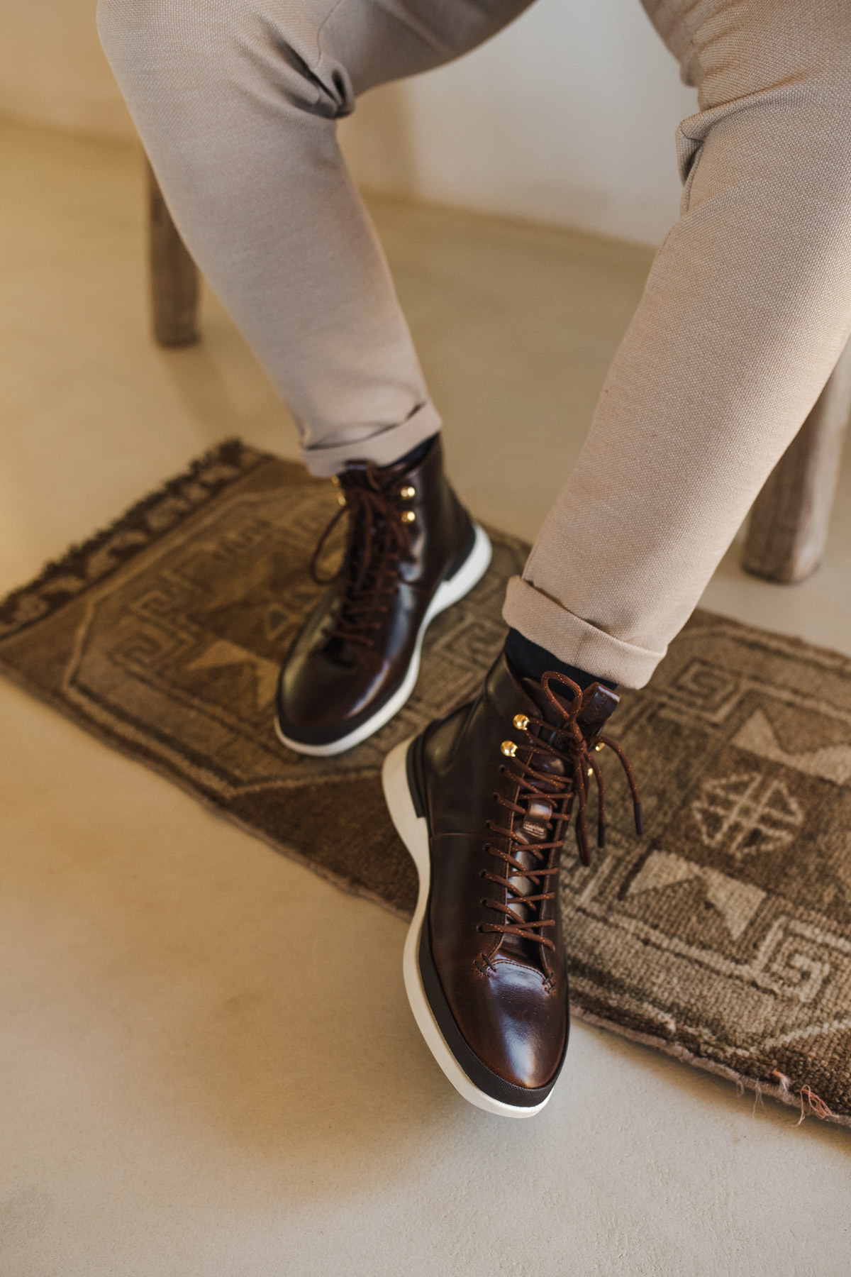 Knee down view of a man sitting wearing Men's boot Crossover Hiker WTZ in Maple