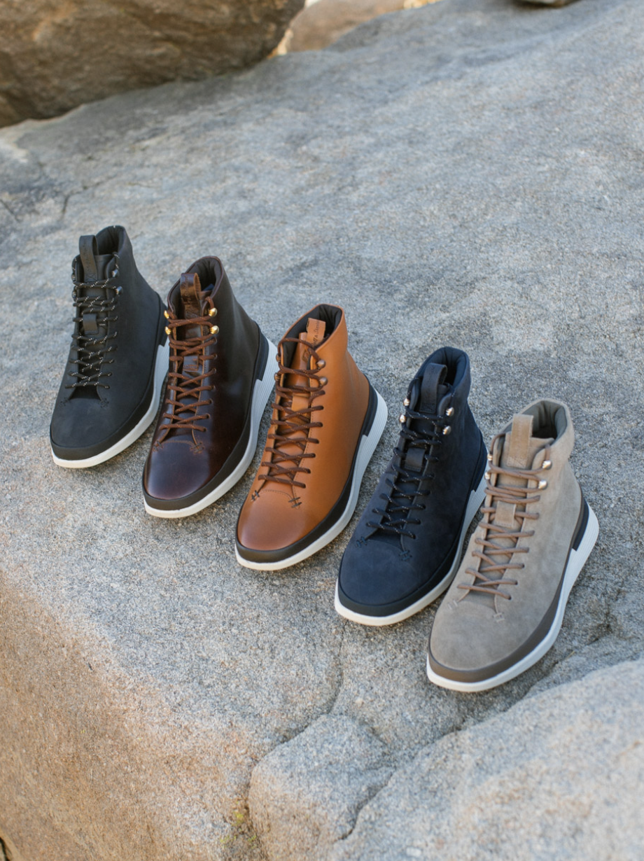 Overhead view of Men's boot Crossover Hiker WTZ in Black, Brown, Maple, Honey, and Rubberized Stone on a rock