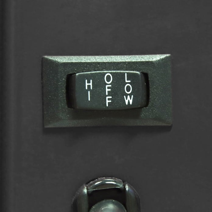 Close-up of the rocker switch located on the side of the fan which controls the high, low, and off speed functions.