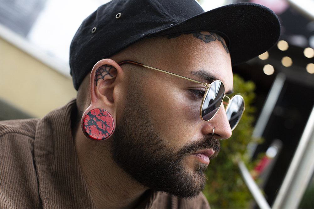 Male wearing unique  Marble Black & Red Stone Plug / Gauge