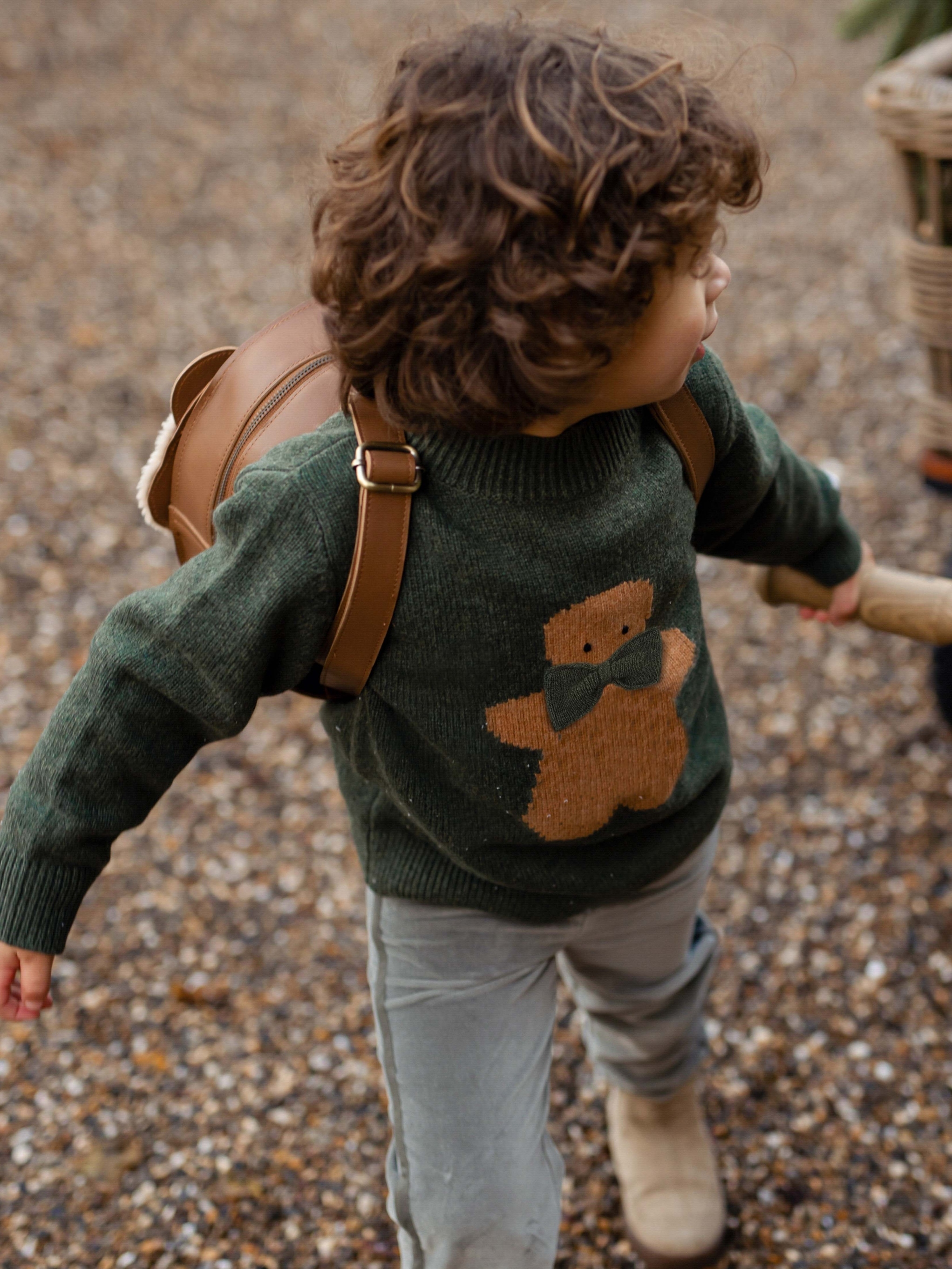 boy wearing gingerbread sweater