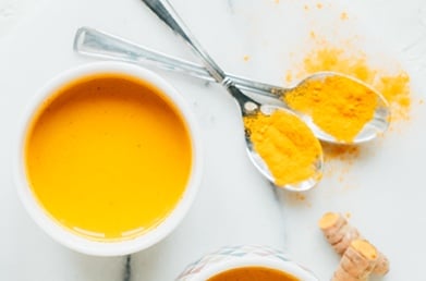 A coffee cup of turmeric latte