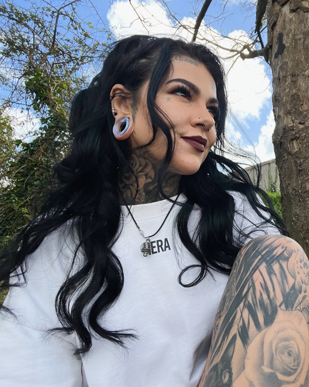Girl wearing alternative  Blue & Green Iridescent Glass Ear Tunnel