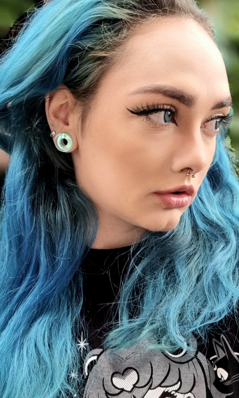 Woman wearing small  Blue & Green Iridescent Glass Ear Tunnel