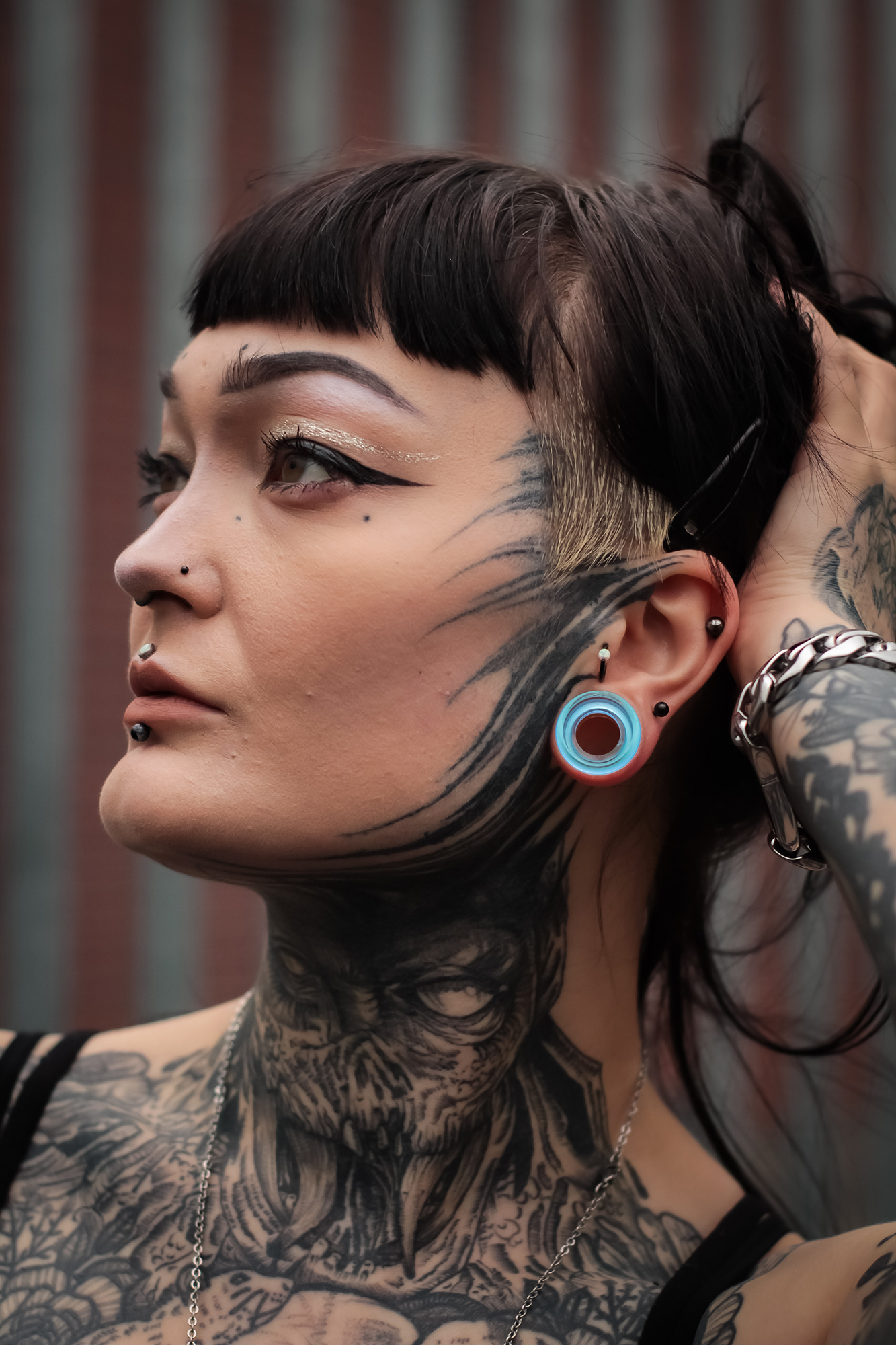 Women wearing unique  Blue & Green Iridescent Glass Ear Tunnel