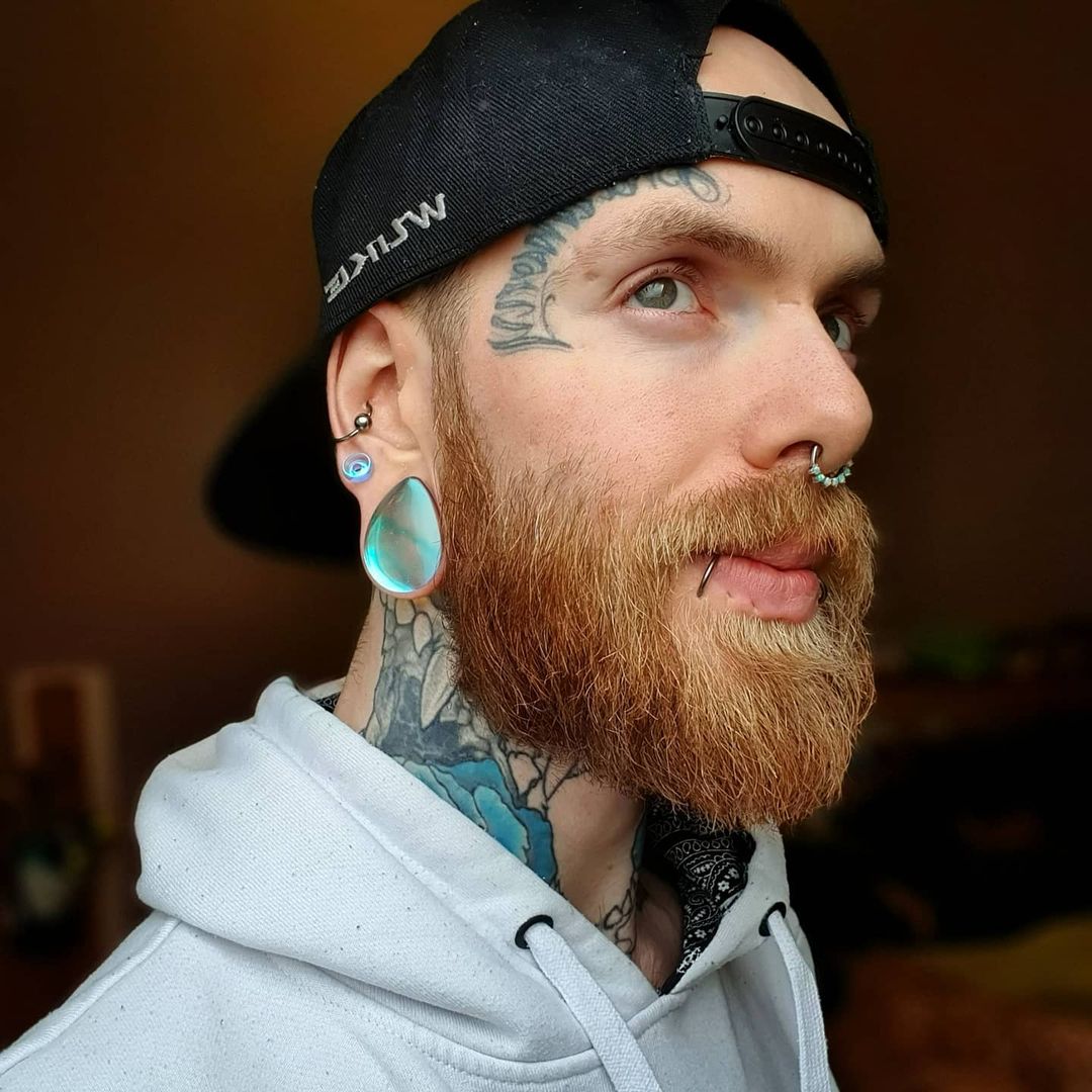 Male wearing large  Blue & Green Iridescent Teardrop  Glass Plug / Gauge