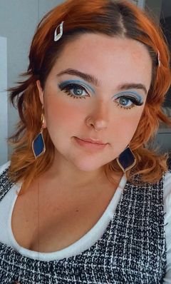 Female wearing pretty  Blue & Gold Steel Dangle Feather Plug / Tunnel / Gauge