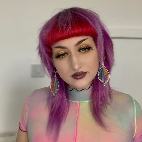 Female wearing cool Multicoloured Silver Steel Dangle Feather Plug / Tunnel / Gauge