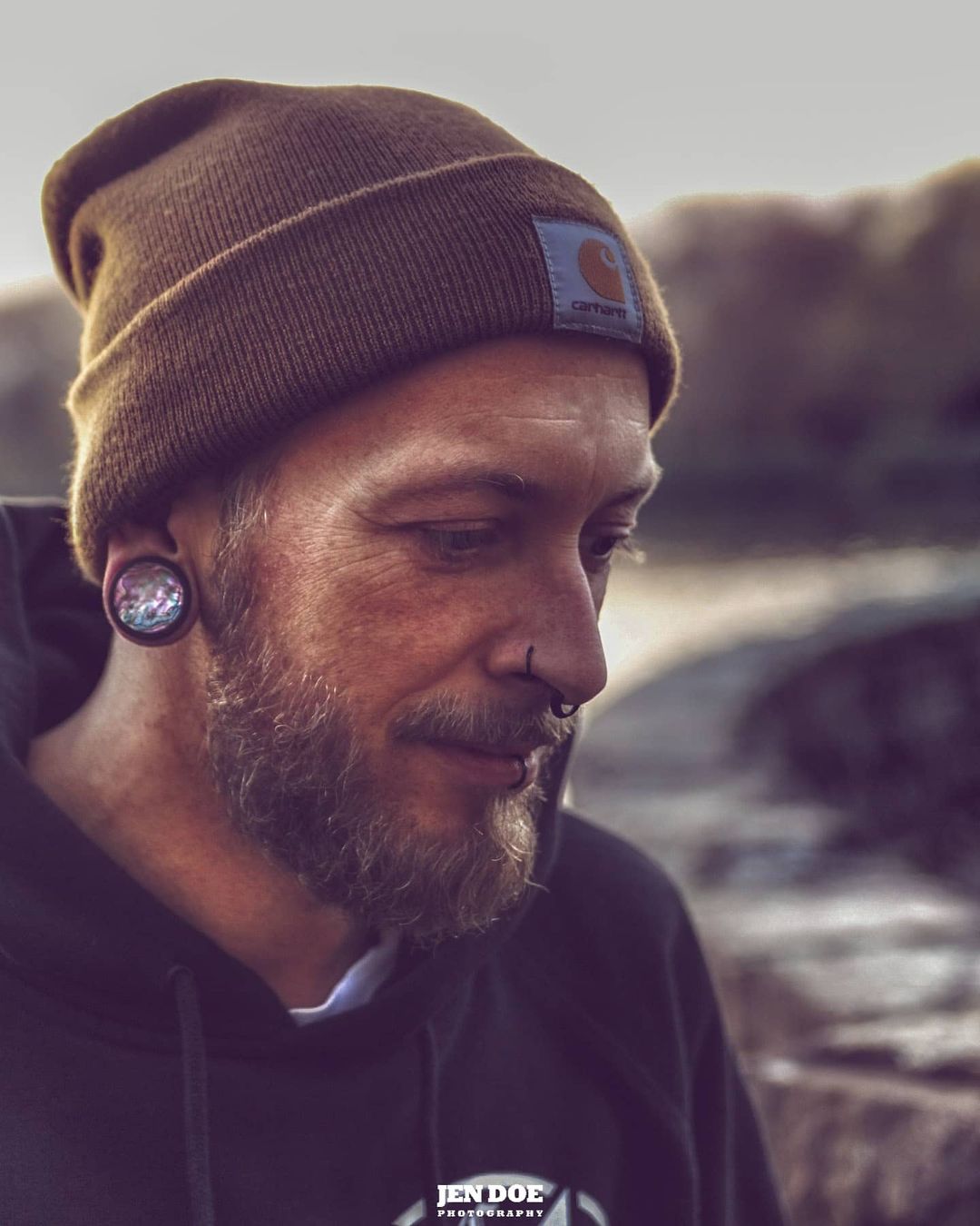 Male wearing unique Midnight Opal & Black Screwback Stainless Steel Tunnel