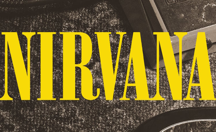 Nirvana lockup in yellow on sepia colored rug background