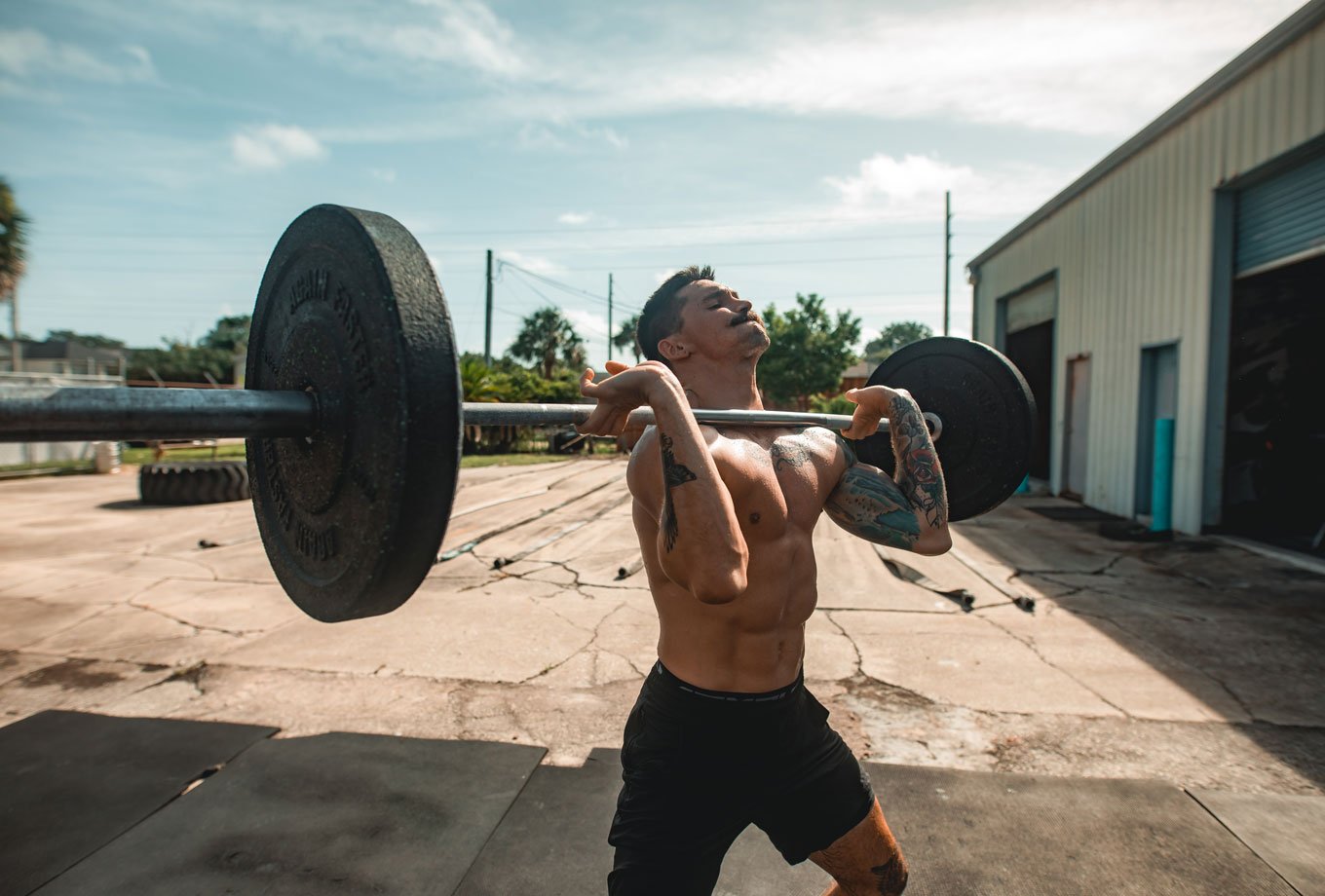 man performing olympic weightlifting jerk