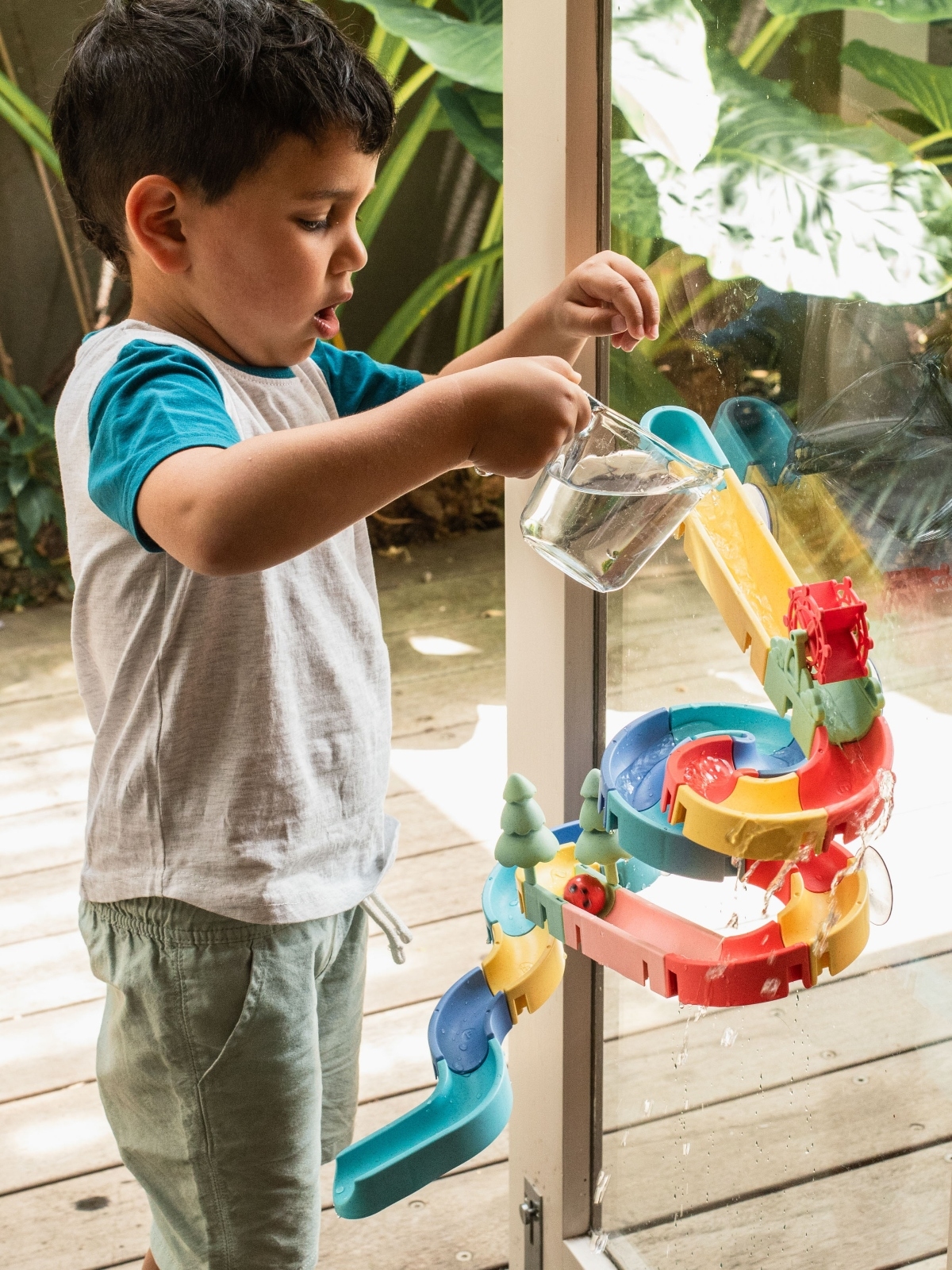 boy playing with marble bath waterslide