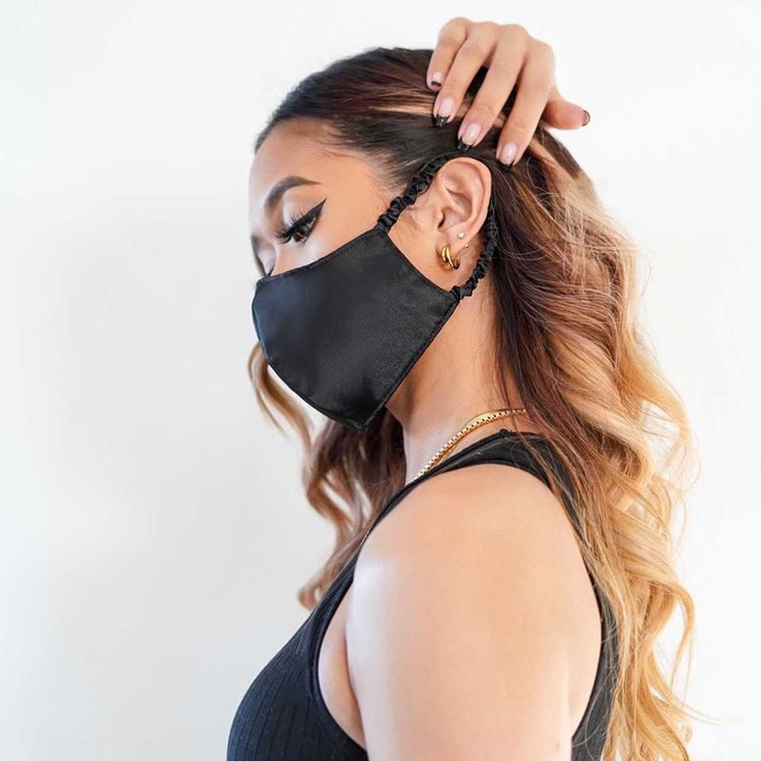 Woman wearing the Fancii reusable face mask in black satin