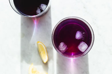 Small glasses of wellness shots made with Navitas Elderberry Powder