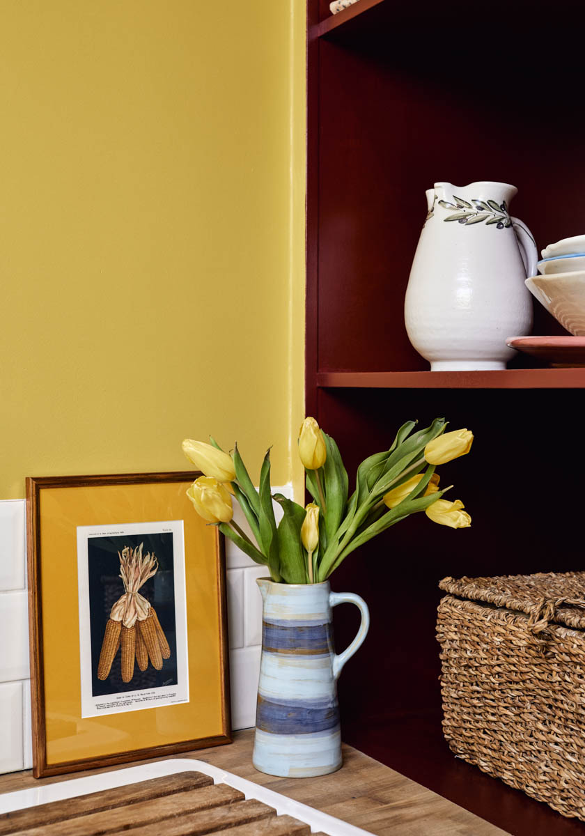Mustard Yellow walls and kitchen cabinetry painted with Haymarket No.47 
