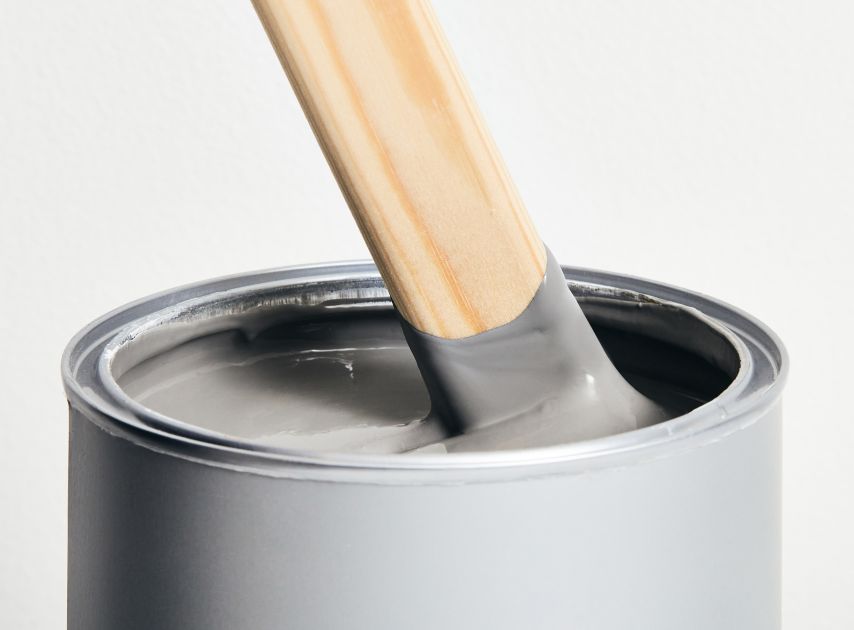 A tin of graphite coloured paint Leadenhall No.118, with a stirrer dipped in it

