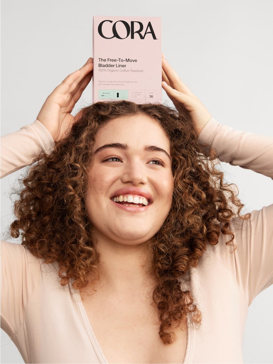 A person holding a box of liners on top of their head