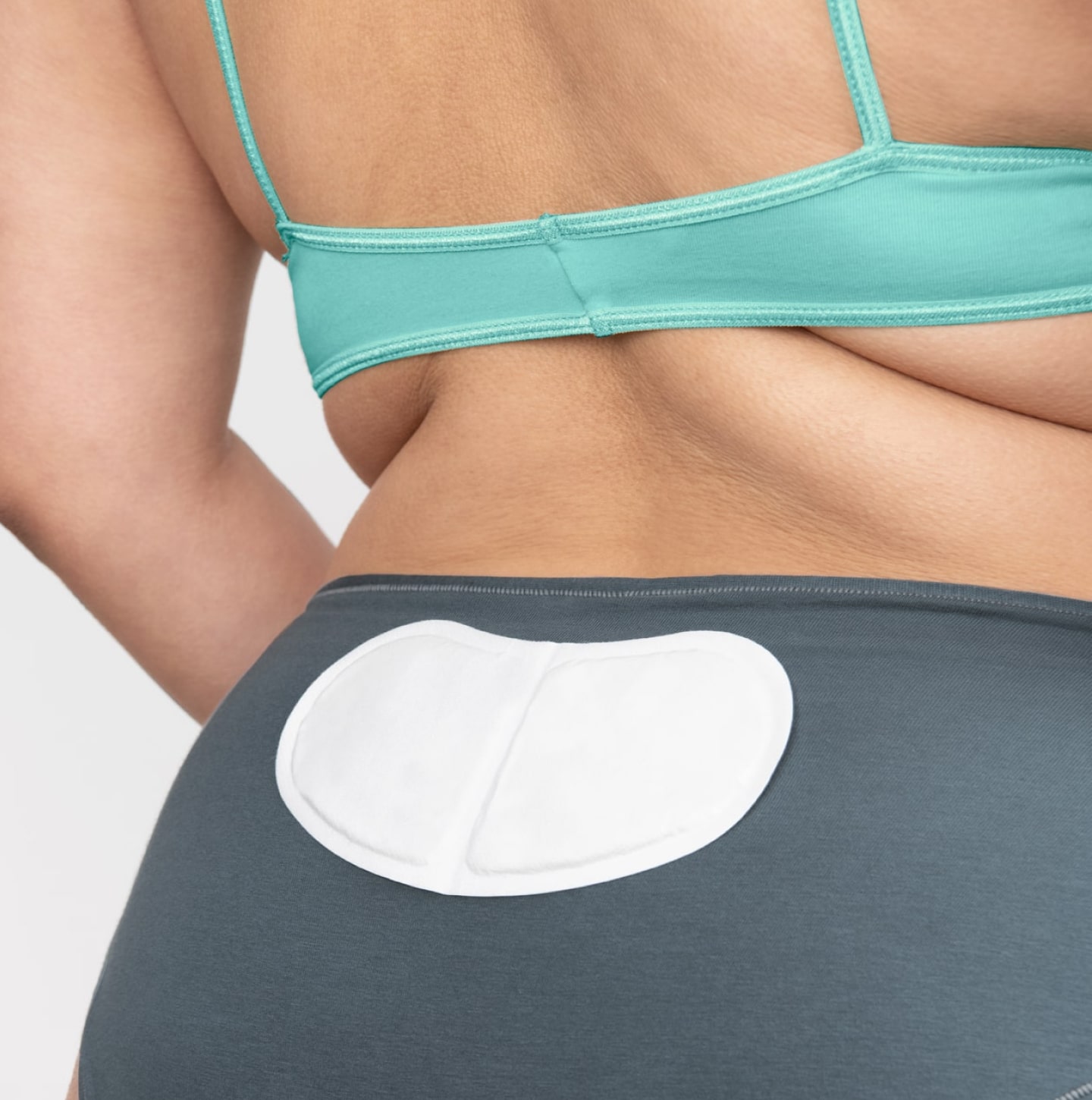 A close up of a person's backside with a heat patch attached to the back of their underwear