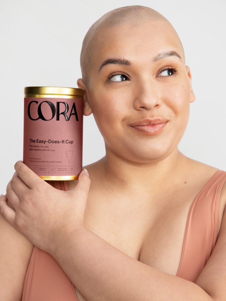 A person holding the package of the Easy-Does-It Cup