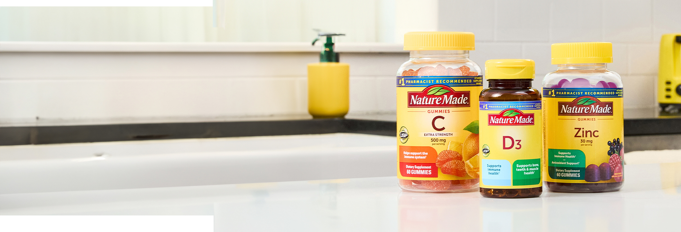 Nature Made immune support supplements on a white kitchen counter.