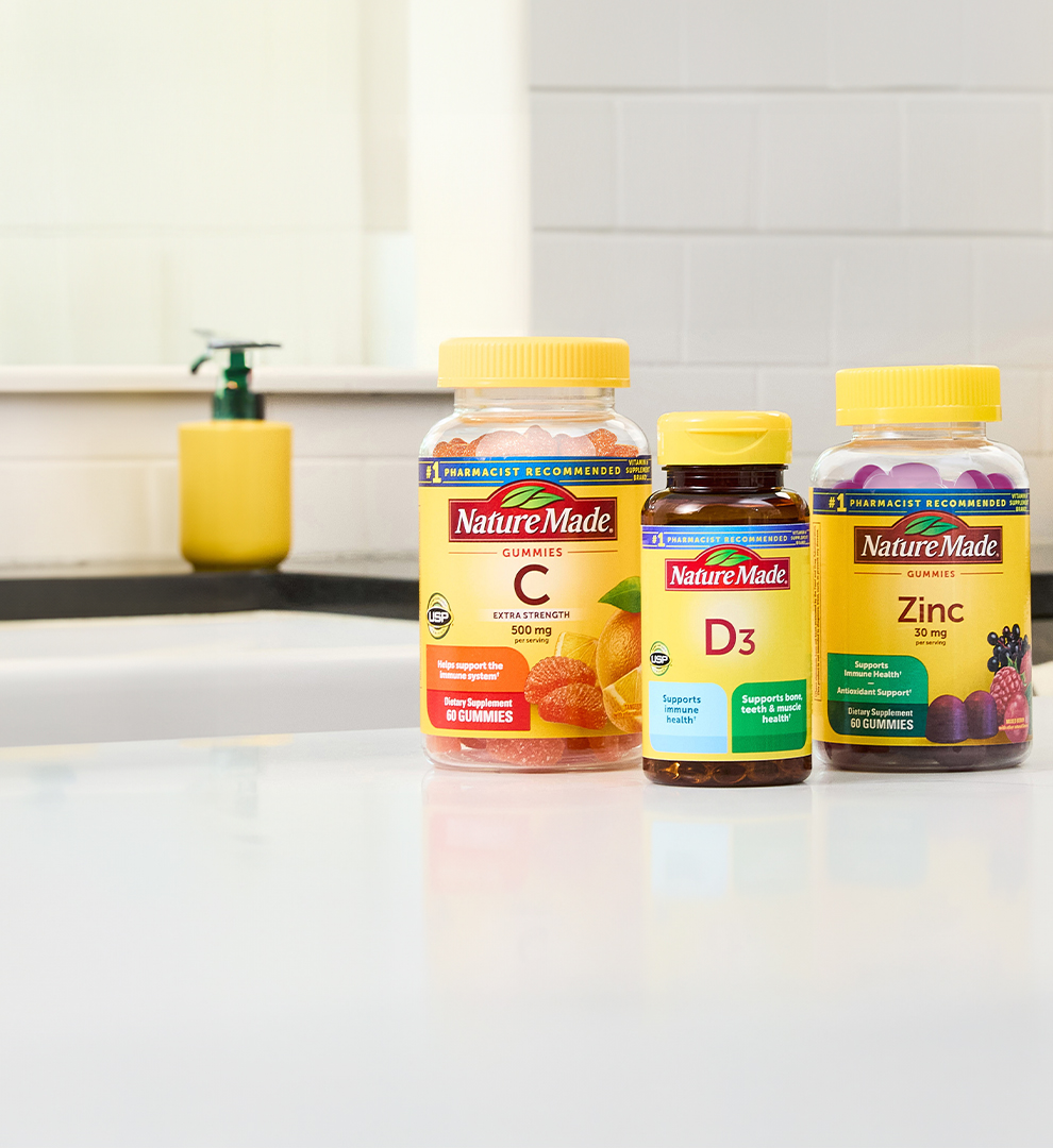 Nature Made immune support supplements on a white kitchen counter.