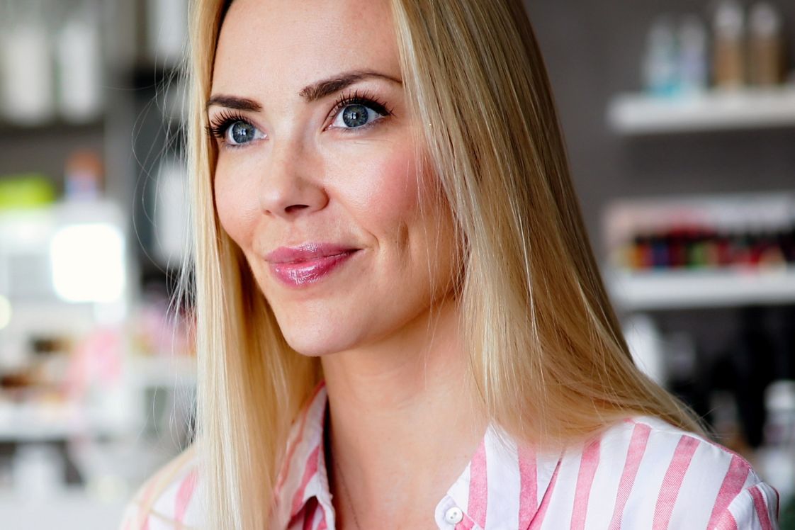 Close-up of a person’s face indoors with shelves in the background