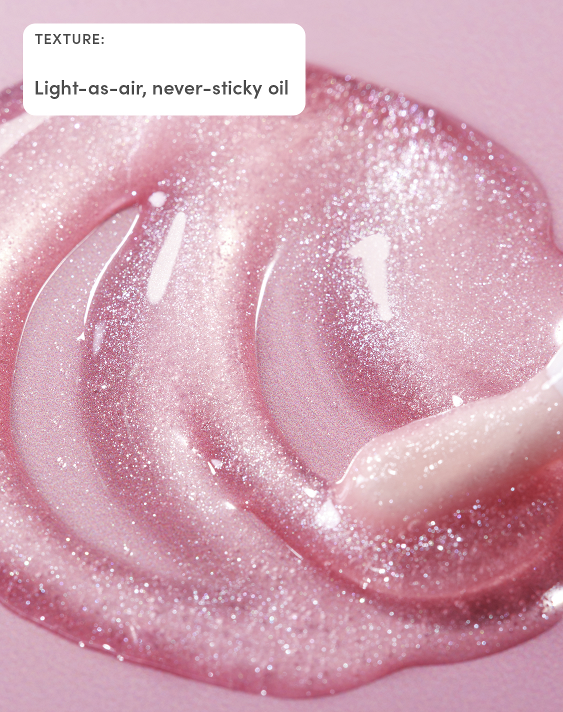 Close-up of Evereden Pink Stardust Lip Oil showing its light-as-air, glossy pink shimmer and non-sticky oil texture.