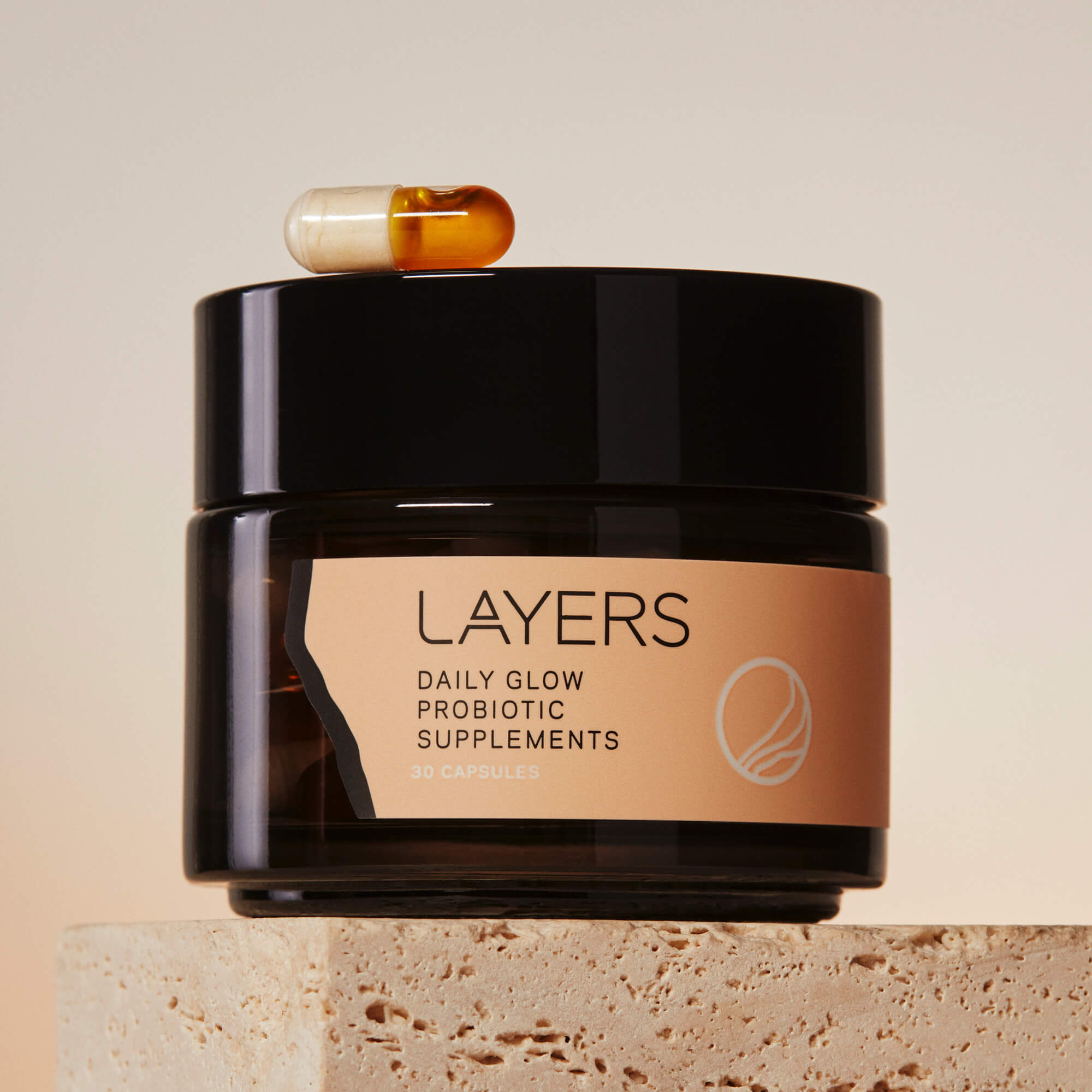 Layers Probiotic Skincare Daily Glow Probiotic Supplements. Semi-Transparent black glass jar with 30 dual-sided capsules. For dry, oily, and combination skin. 