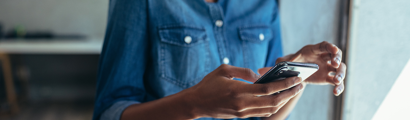 Woman using smart phone in the office