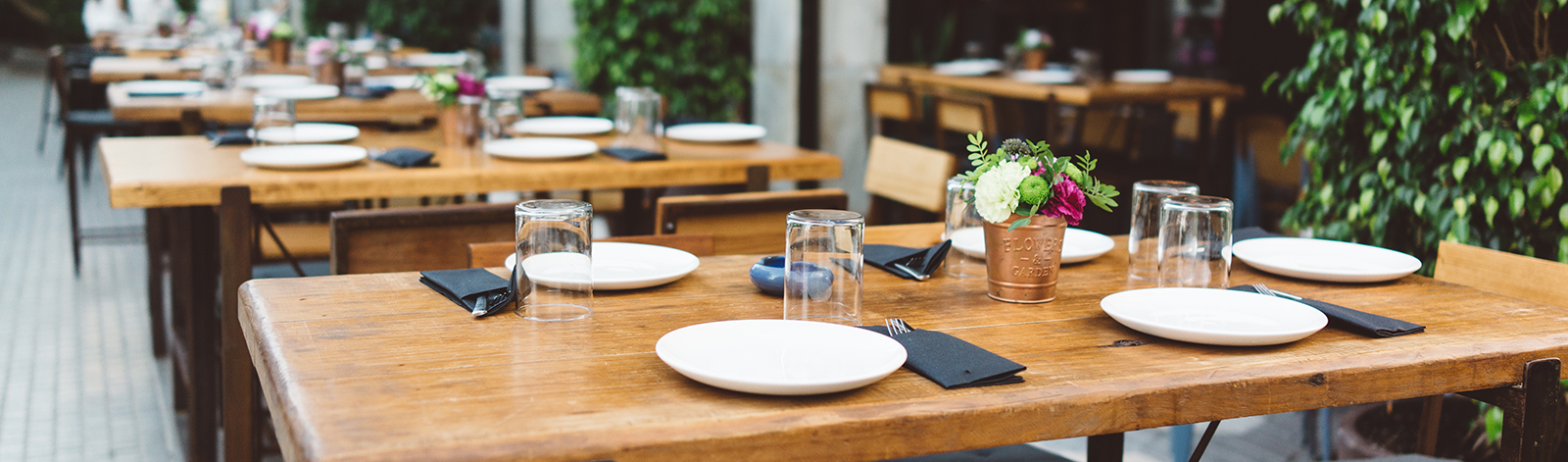 Dishes on the wooden table in outdoor restaurant