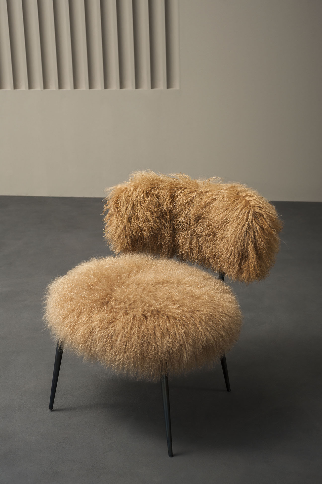 The Nepal chair was designed by Paola Navone and is upholstered in Mongolian sheepskin. Photo c/o Baxter. 