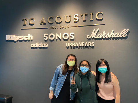 Interns in front of TC Acoustic wall