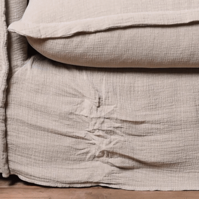 Animation of person steaming out wrinkles on a slipcovered sofa