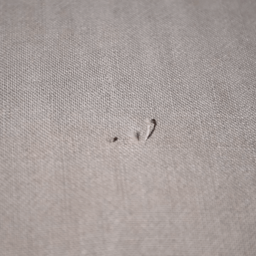 Animation of a person snipping a loose thread on a slipcover