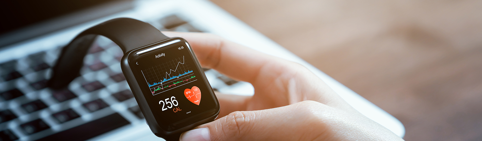 Close up of hand touching smartwatch with health app on the screen