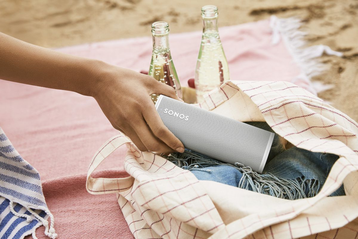 Sonos roam in a tote bag at a picnic on the beach
