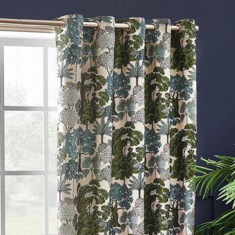 A green curtain panel with an intricate jacquard design of forest florals.