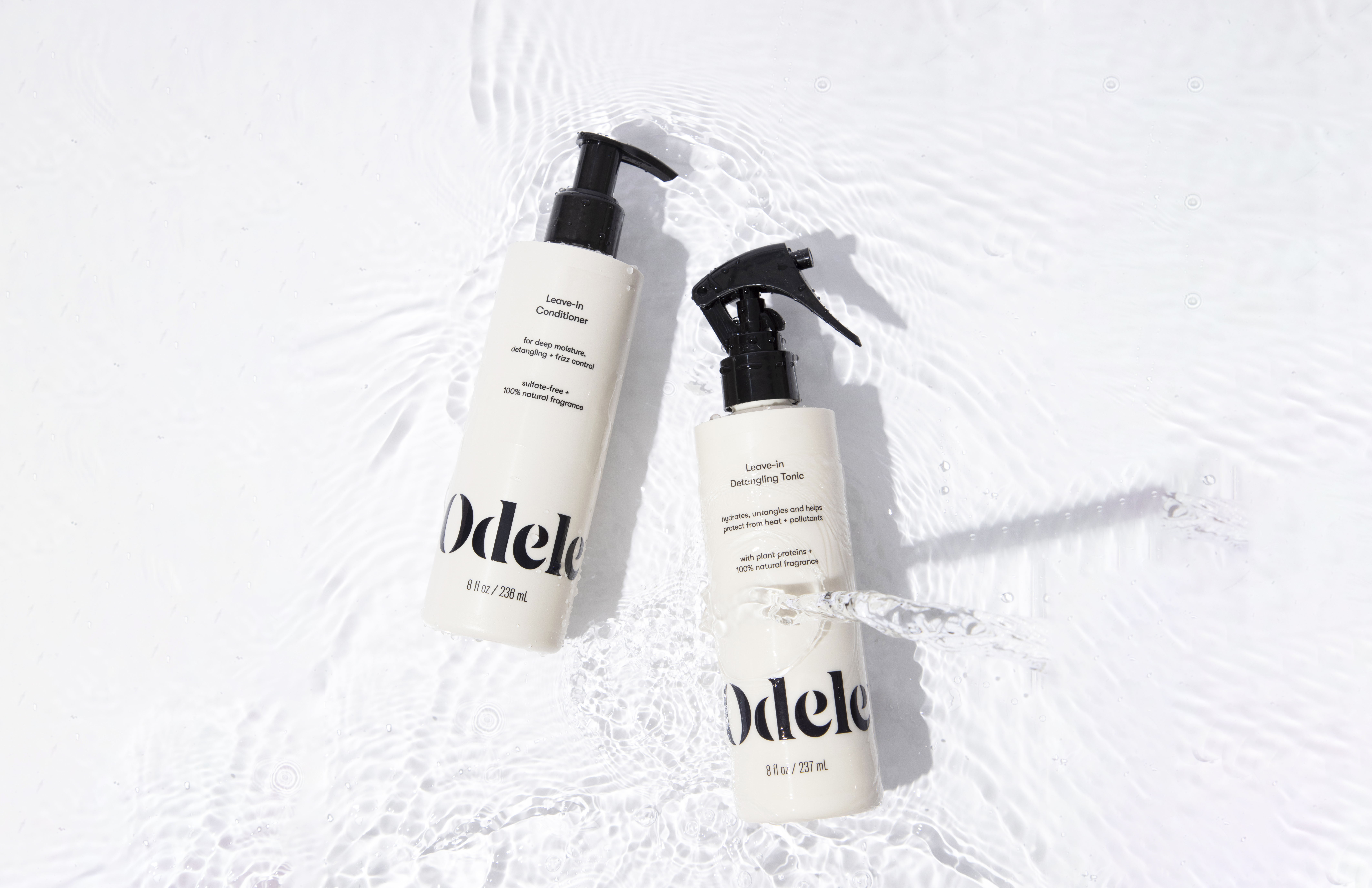 Odele Leave-in Conditioner and Leave-in Detangling Tonic floating in water