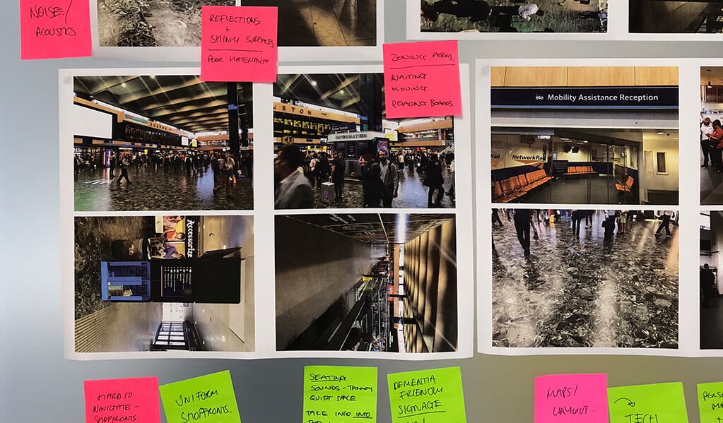 Various photos of London underground on a board with coloured sticky post it notes on. 
