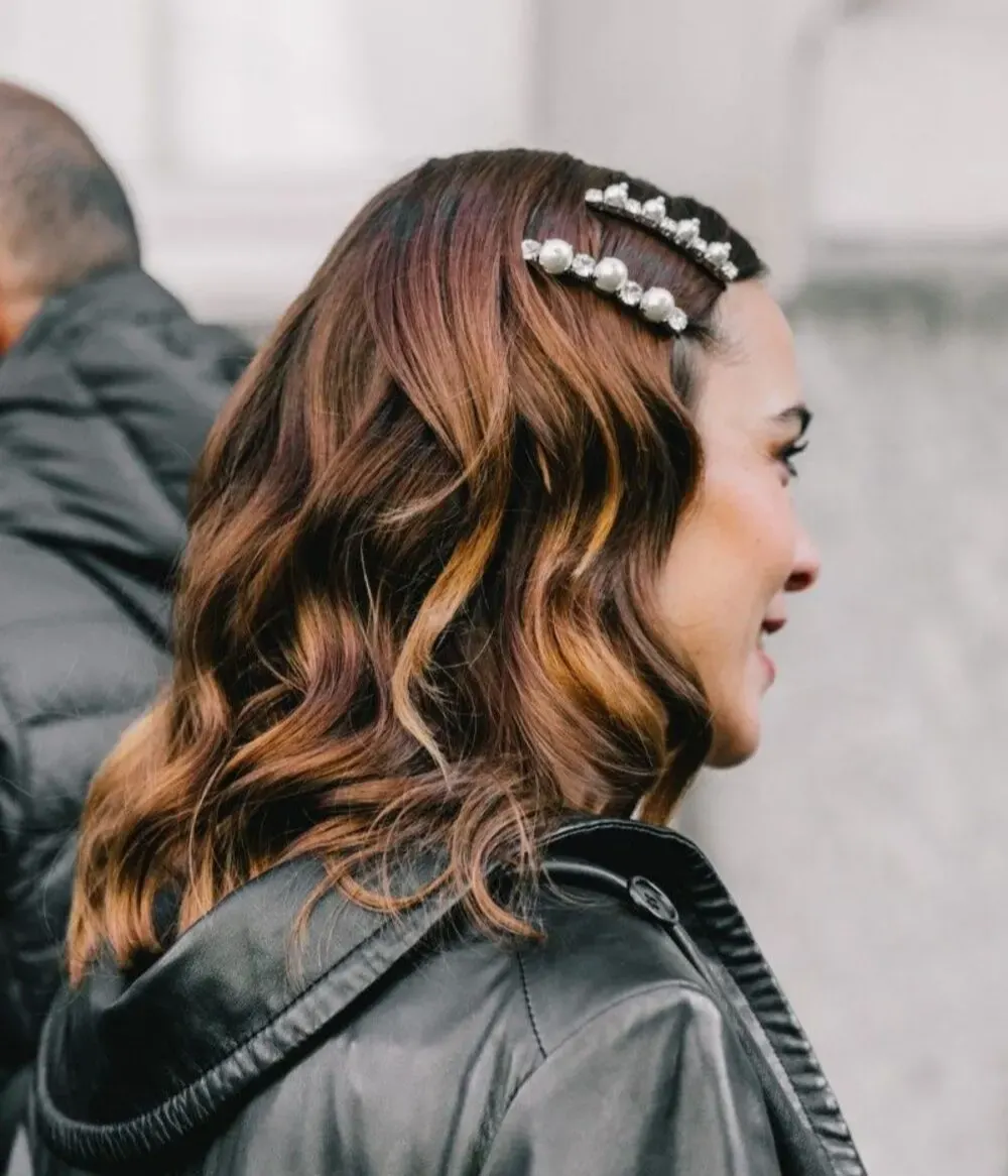 Person wearing pearl adorned barrettes 