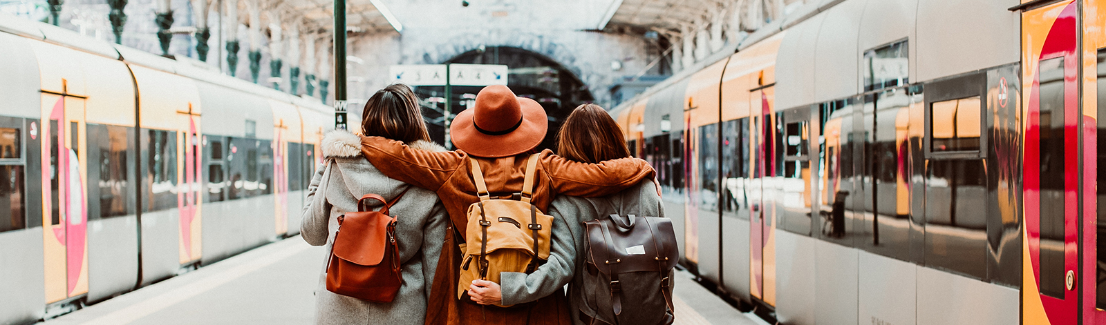 A group of young friends catching a train at the station