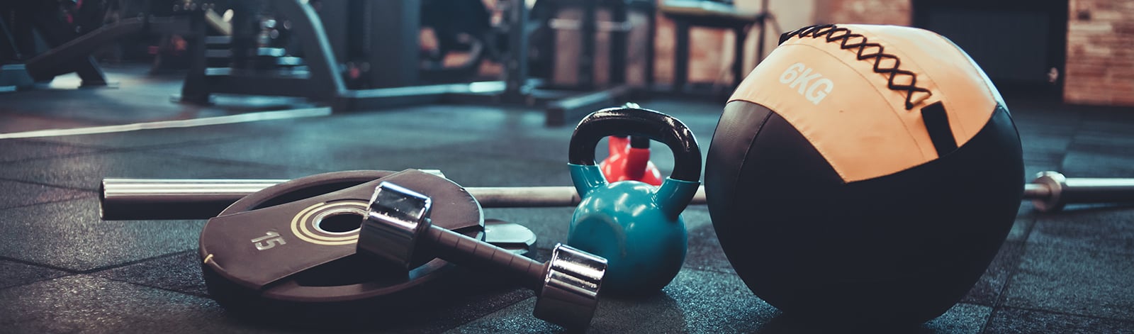 Medicine ball, dumbbell, kettlebell and other equipment on the gym floor