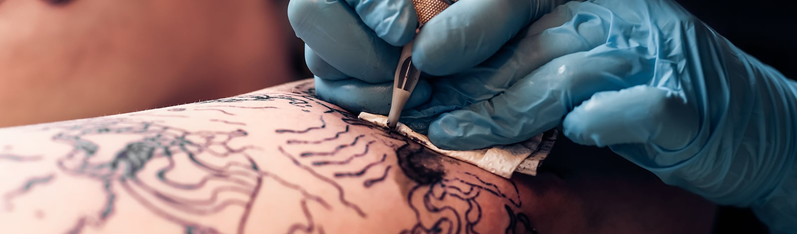 Close up of a tattoo artist at work