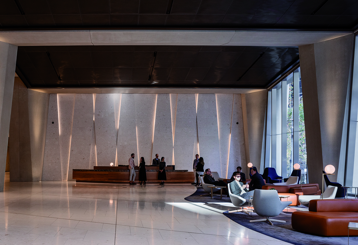 The commercial tower lobby with its expressive concrete form, and furniture by B&B Italia including the Harbor and Metropolitan armchairs. Photography © Trevor Mein. 