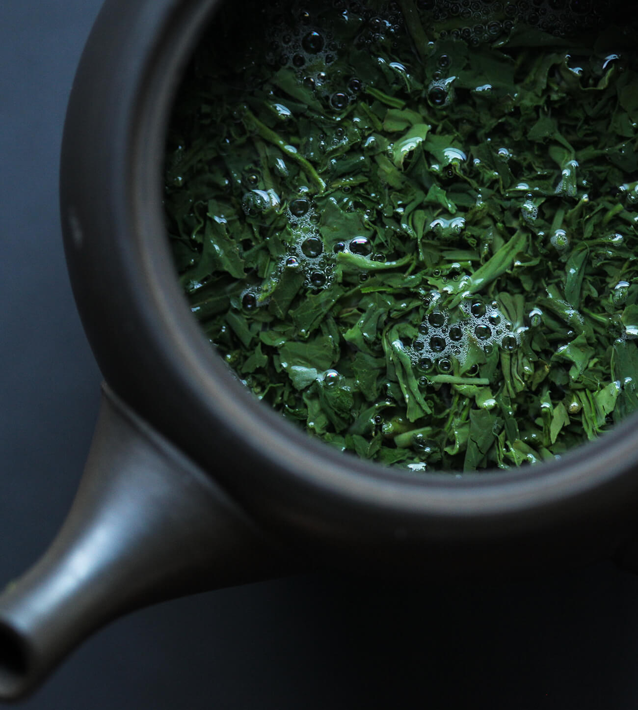 Steeping green tea in a small clay teapot